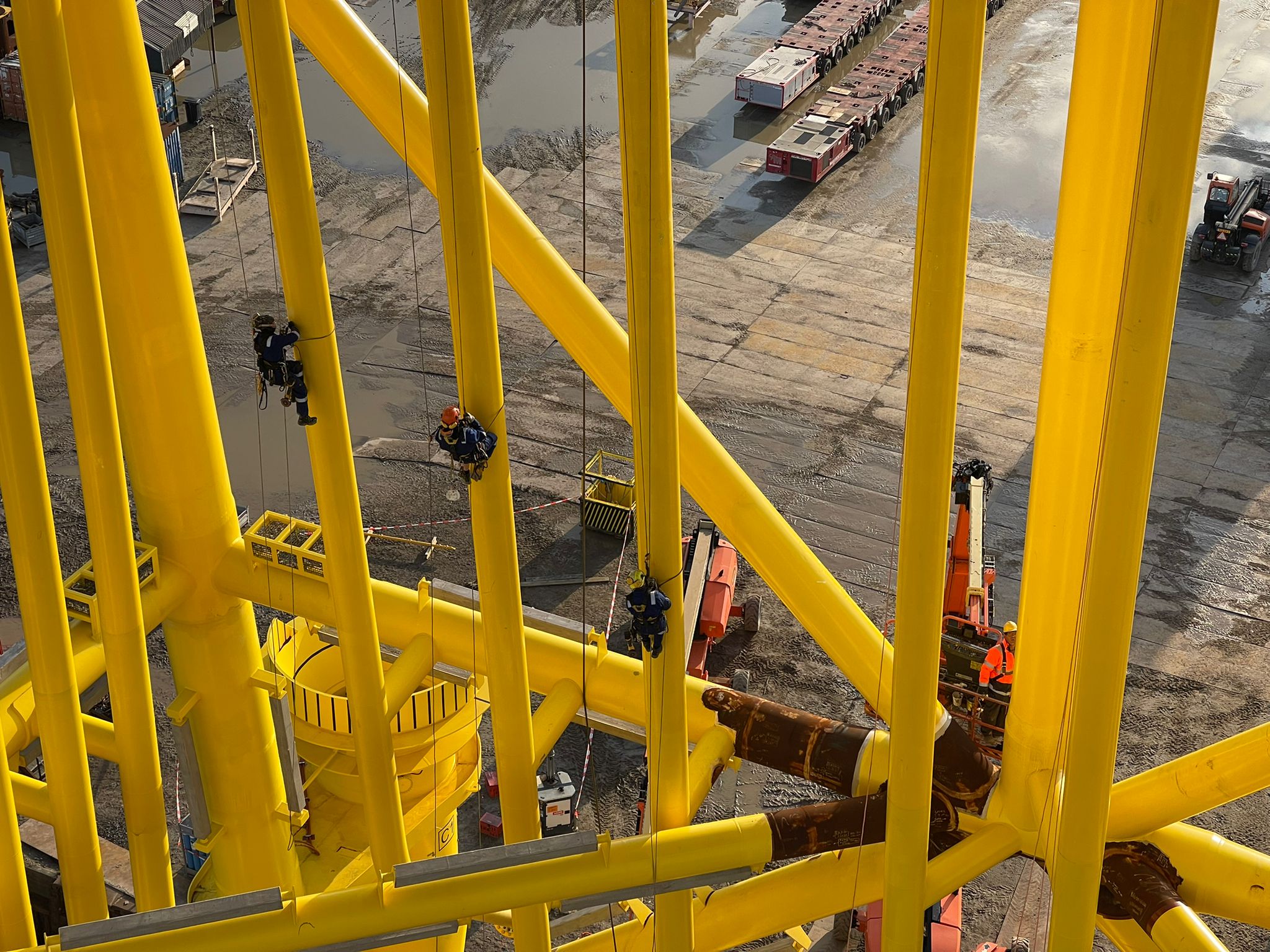 Rope access team working on a yellow steel structure