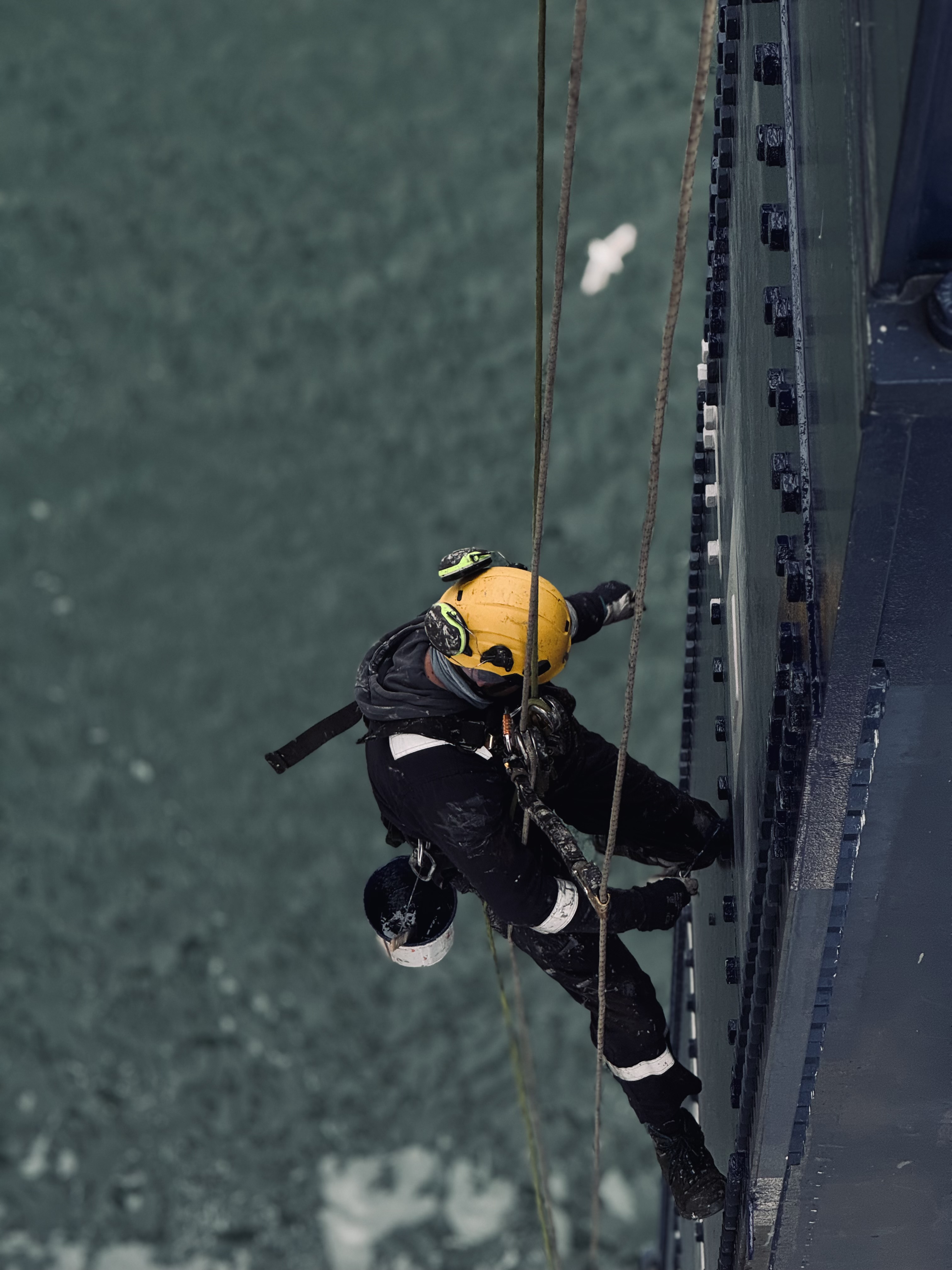 Technician carrying out surface maintenance on structural steel