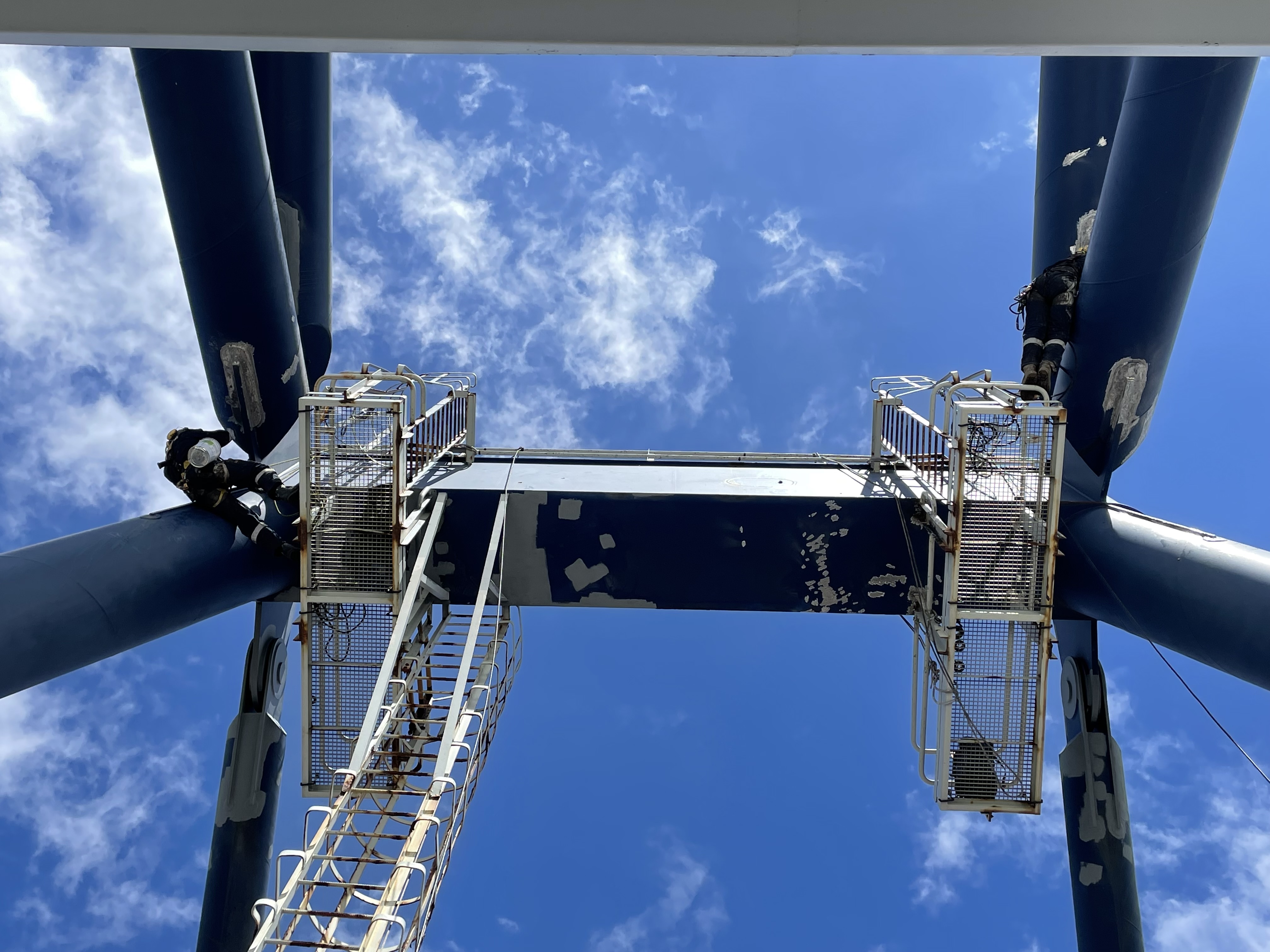 Rope access technicians working on large steel supports