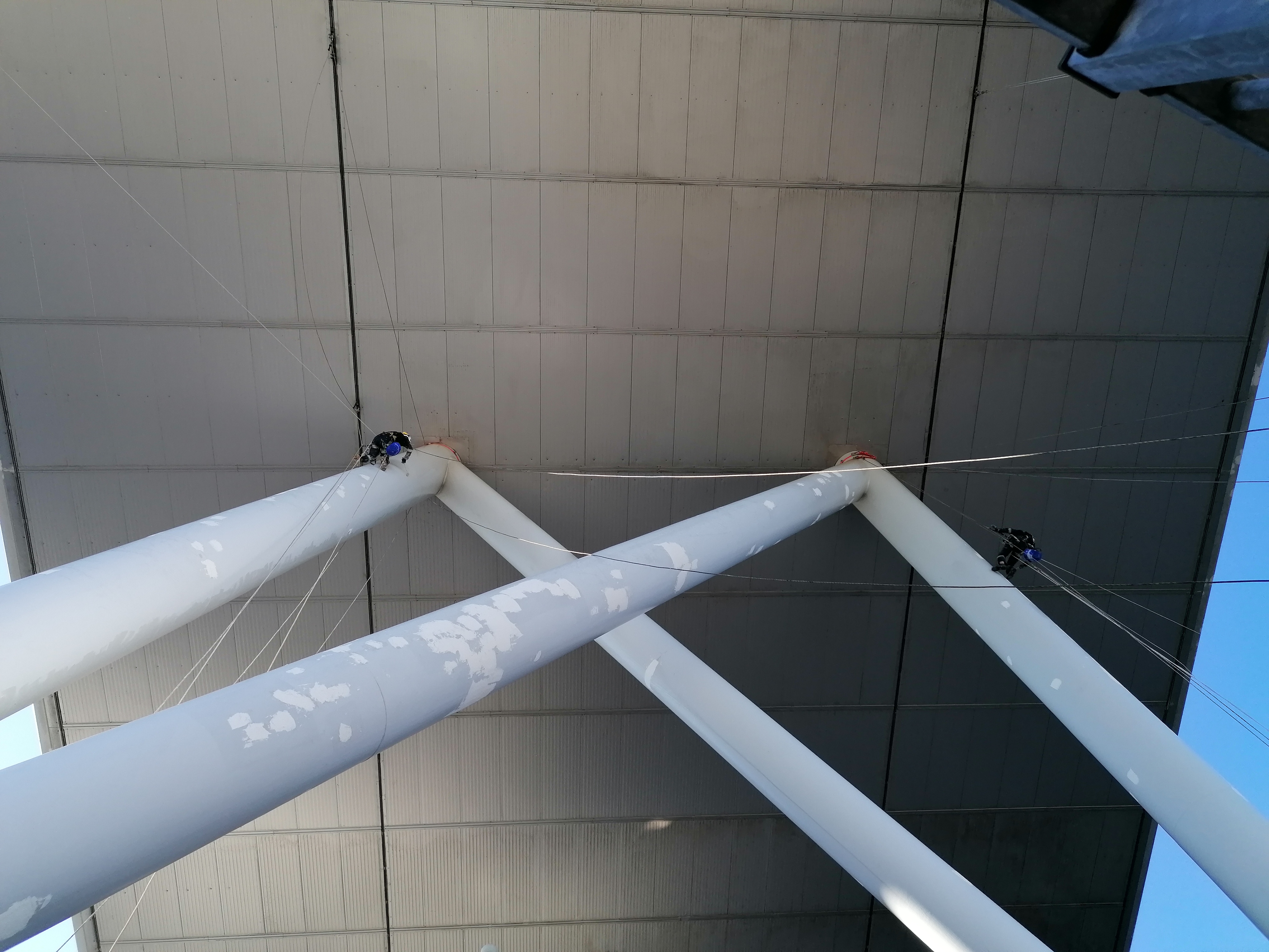 Surface repair work on structural supports beneath a roof
