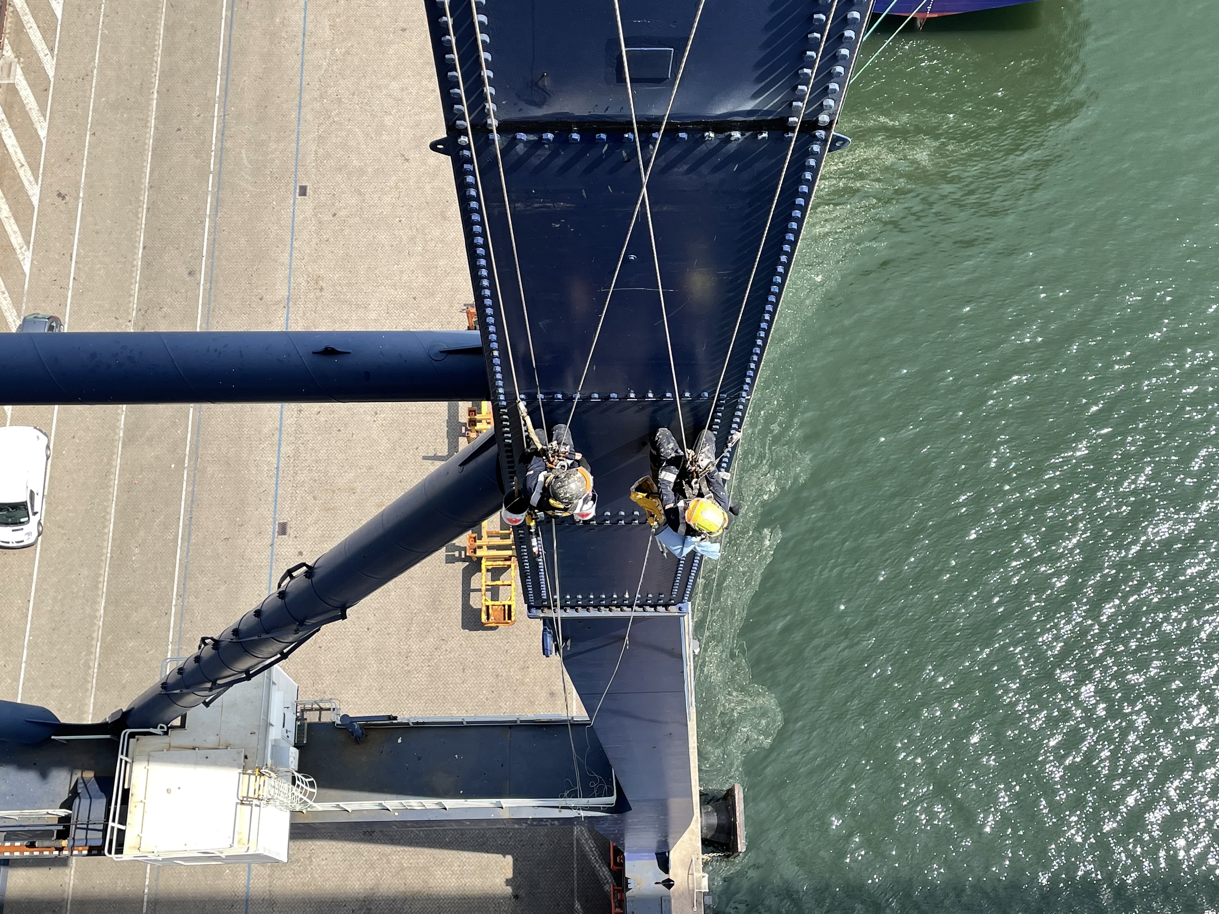 Two rope access technicians working on a steel structure