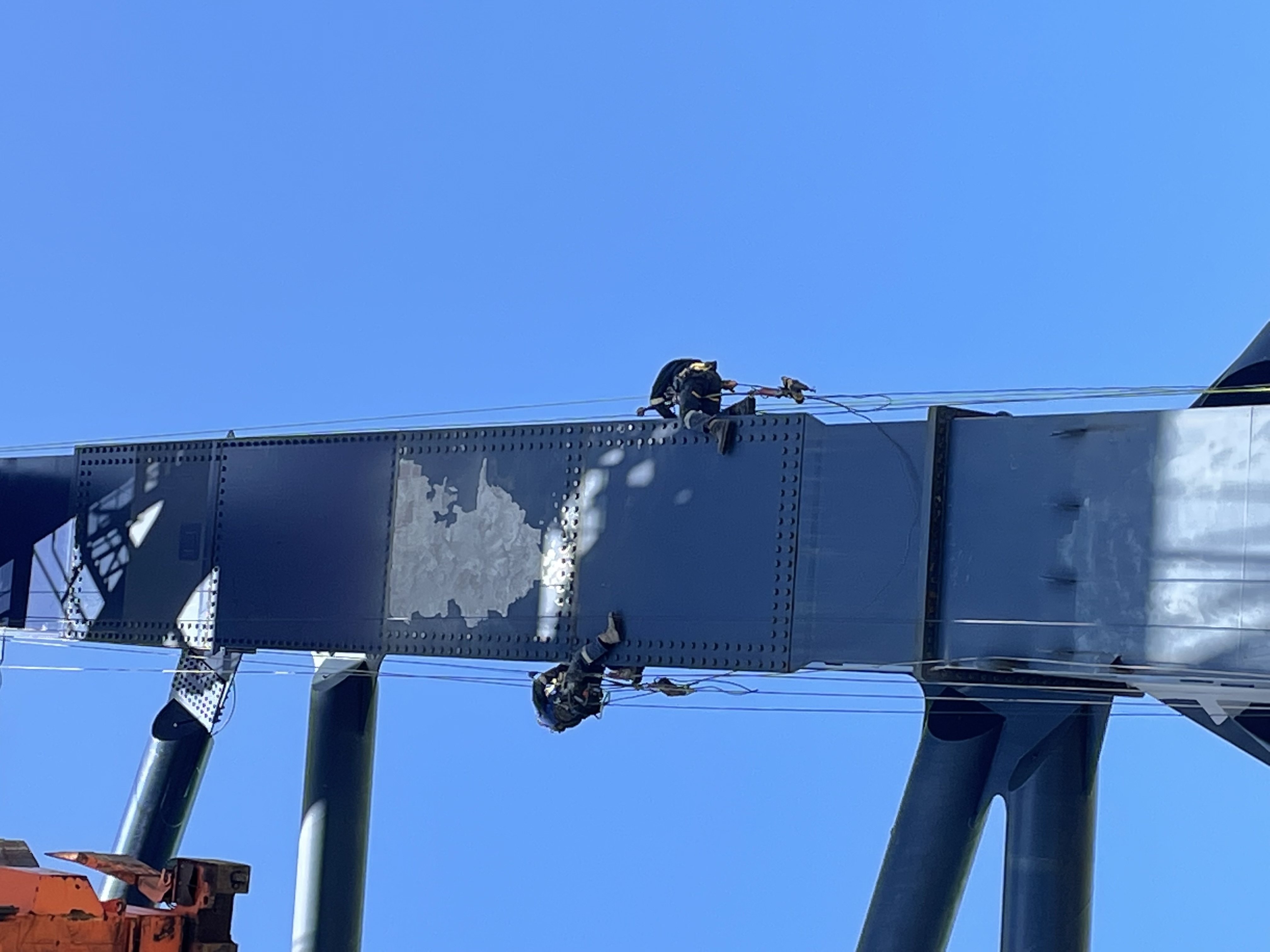 Rope access technicians carrying out spot repairs on a steel structure