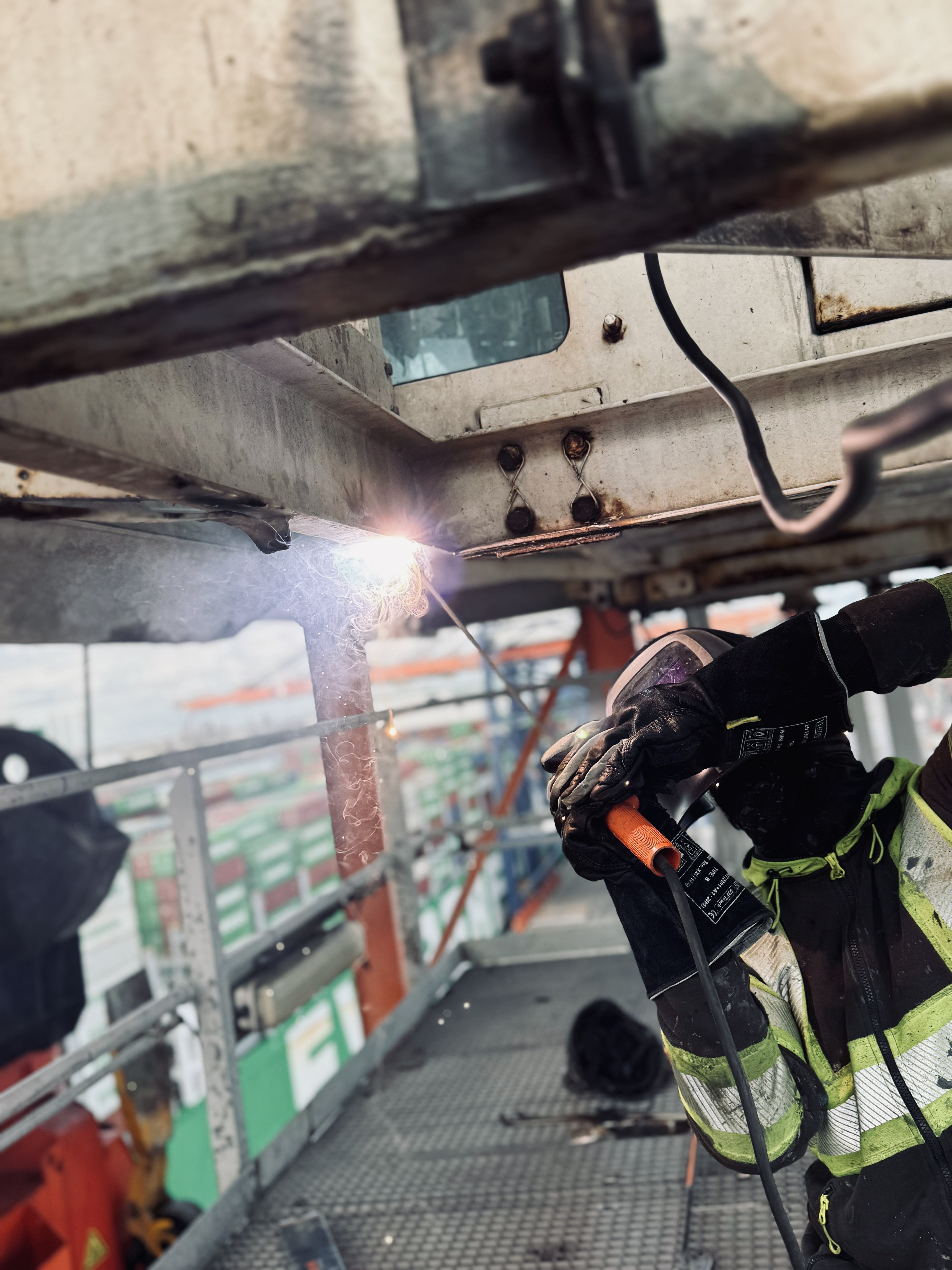Welder carrying out repairs on a metal structure